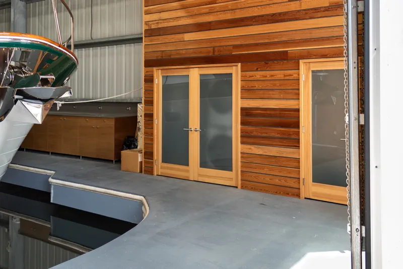 Slide: The Image of Custom 1969 all-steel boathouse interior with wooden doors and docked boat. - 14