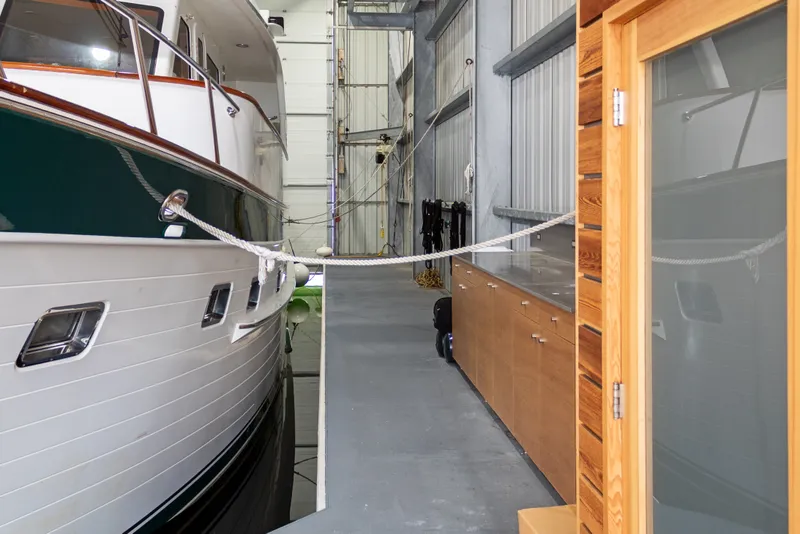 Slide: The Image of Custom 1969 all-steel boathouse interior with docked yacht and wooden cabinetry. - 17