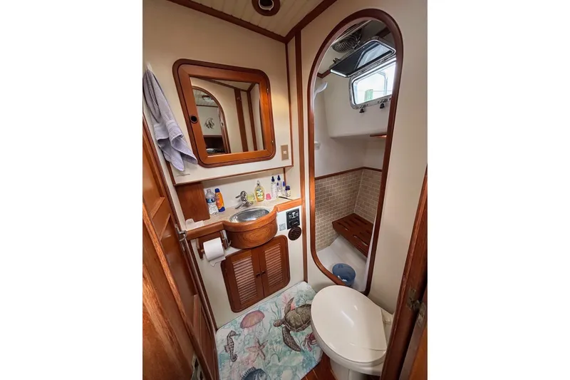 Slide: The Image of Bathroom interior of 1988 Hans Christian Independence 45 yacht, featuring wooden accents and nautical decor. - 12