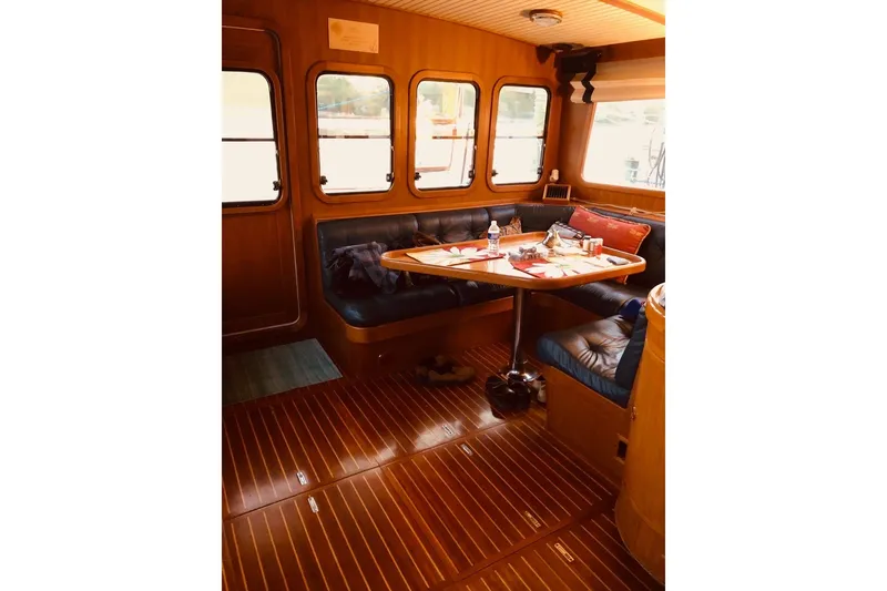 Slide: The Image of Interior of 1988 Hans Christian Independence 45 yacht with wooden flooring and cozy seating area. - 17