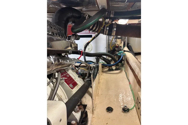 Slide: The Image of Engine compartment of a 1988 Hans Christian Independence 45 sailboat, showcasing hoses and components. - 19