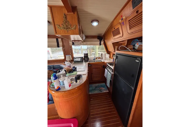 Slide: The Image of Interior of 1988 Hans Christian Independence 45 yacht, featuring a cozy kitchen area. - 13