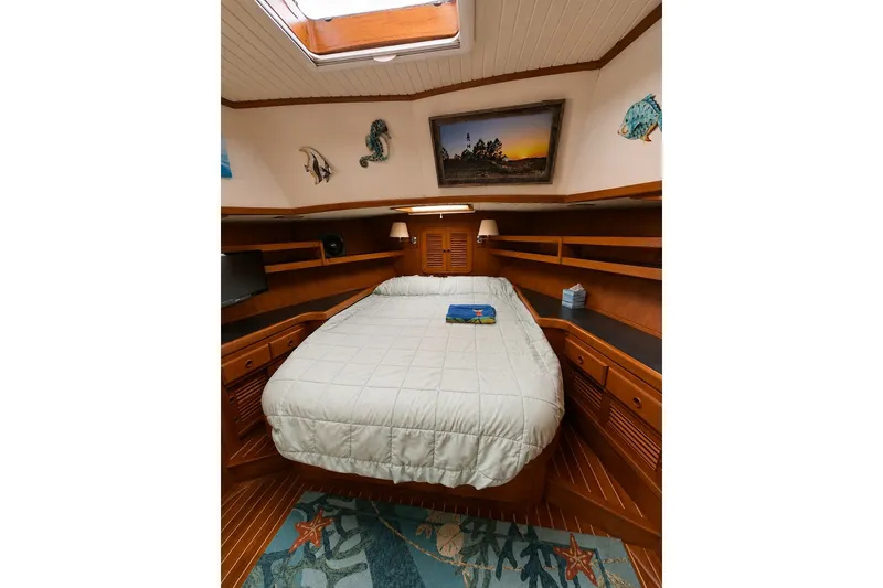Slide: The Image of Luxurious cabin interior of 1988 Hans Christian Independence 45 yacht with cozy bed and wooden finish. - 6