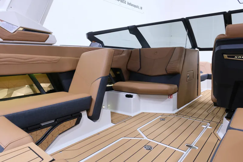 Slide: The Image of The image shows the interior of a 2027 Nautique G23 boat with sleek brown seating and modern design. - 18