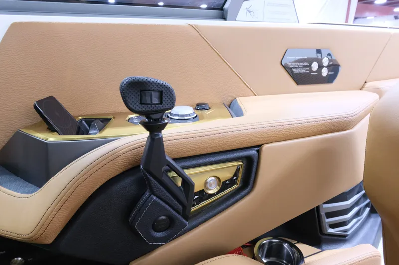 Slide: The Image of The image shows the cockpit of a 2027 Nautique G23 with sleek controls and luxurious upholstery. - 20