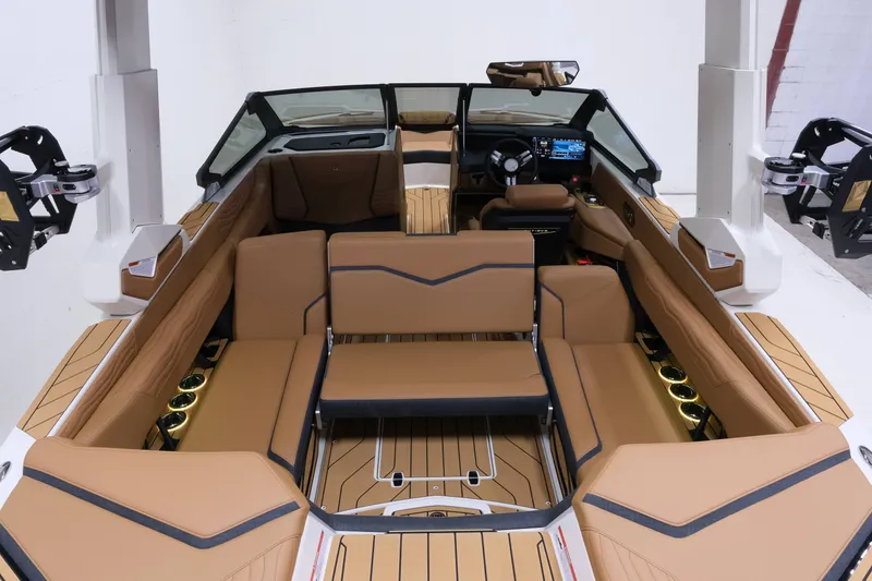 Slide: The Image of The image shows the interior of a 2027 Nautique G23 boat with luxurious brown seating. - 10