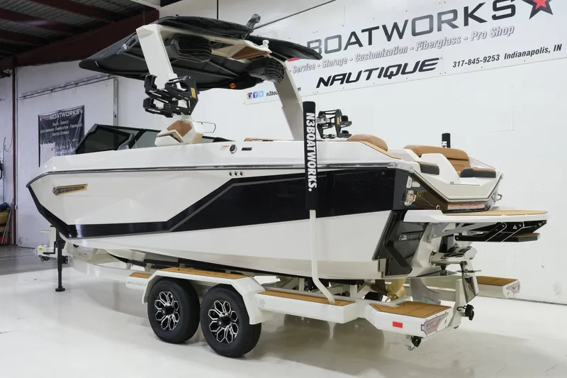 Slide: The Image of A modern 2027 Nautique G23 sits on a trailer in a showroom. - 6