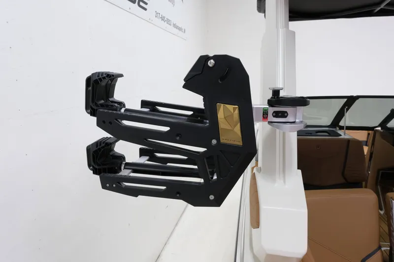Slide: The Image of A modern wakeboard rack on a Nautique G23 boat, featuring a sleek black design. - 22