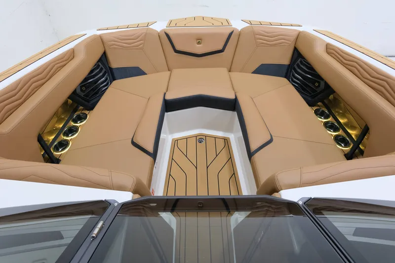 Slide: The Image of The image shows the interior of a 2027 Nautique G23 boat with luxurious beige upholstery. - 16