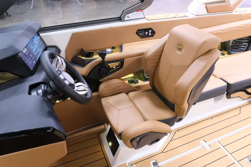 Slide: The Image of The image shows the interior of a 2027 Nautique G23 with a luxurious leather captain's chair. - 15