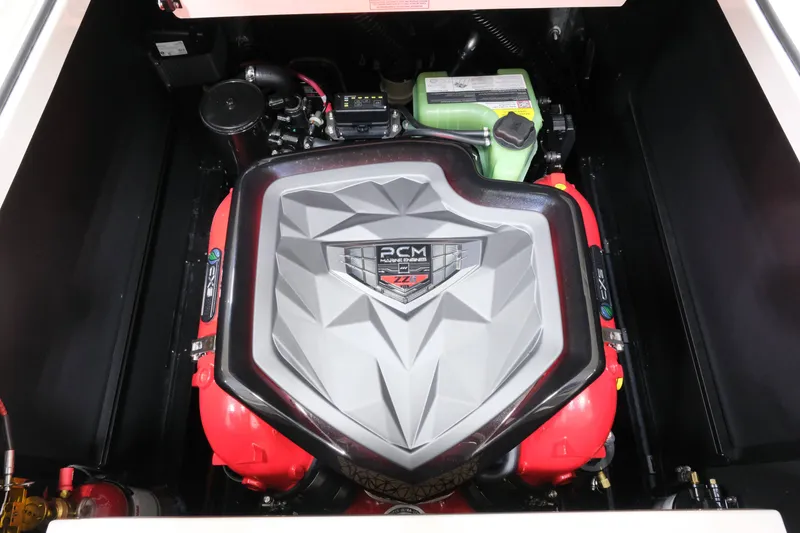Slide: The Image of The engine compartment of a 2027 Nautique G23 features a powerful PCM engine with red accents. - 23