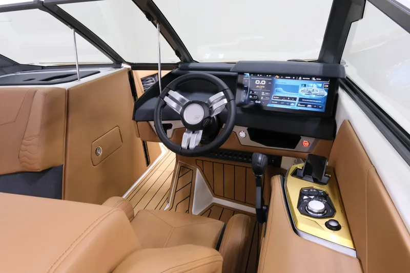 Slide: The Image of The image shows the cockpit of a 2027 Nautique G23 with a modern steering wheel and digital display. - 13
