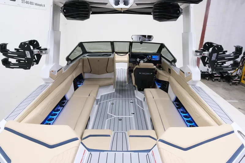 Slide: The Image of The image shows the interior of a Nautique G25 boat with beige seats and blue lighting. - 9