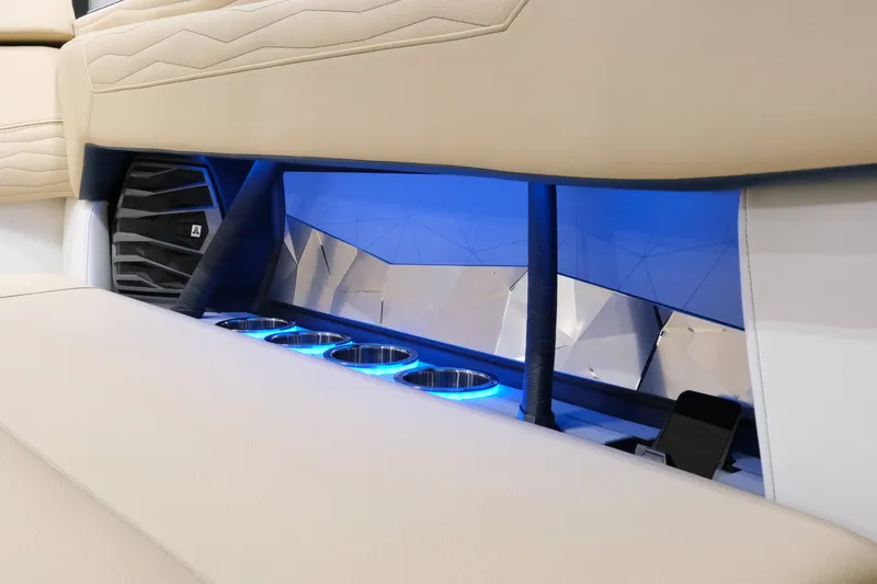 Slide: The Image of The image shows the interior of a 2027 Nautique G25 with blue LED lighting and cup holders. - 19