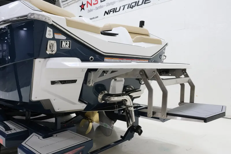 Slide: The Image of The image shows the stern of a 2027 Nautique G25 boat with a swim platform. - 7