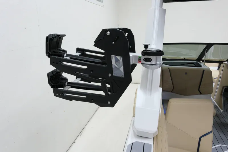 Slide: The Image of A modern boat with a black wakeboard holder and beige seating. - 21