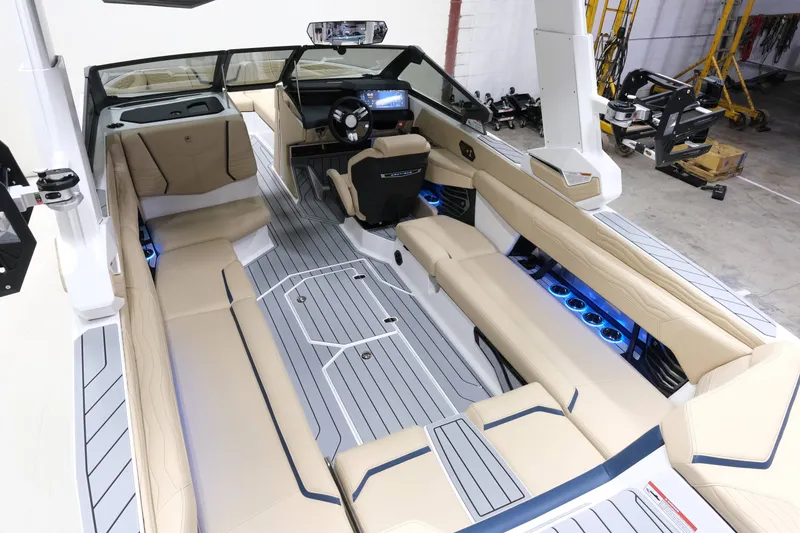 Slide: The Image of The image shows the interior of a 2027 Nautique G25 boat with luxurious seating and modern design. - 12