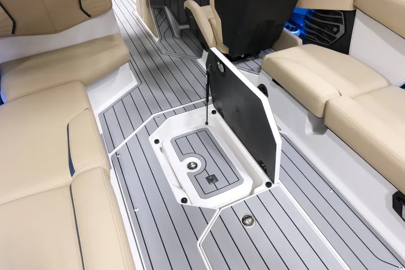 Slide: The Image of The image shows the interior of a Nautique G25 boat with beige seats and gray flooring. - 20