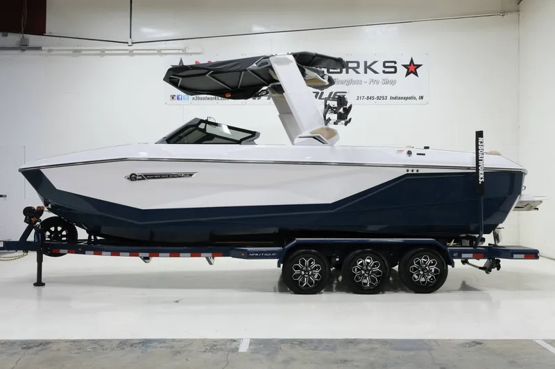 Slide: The Image of A modern 2027 Nautique G25 sits on a trailer in a showroom. - 4