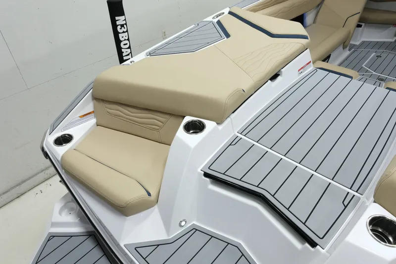 Slide: The Image of The image shows the deck of a 2027 Nautique G25 boat with beige upholstery and gray flooring. - 8