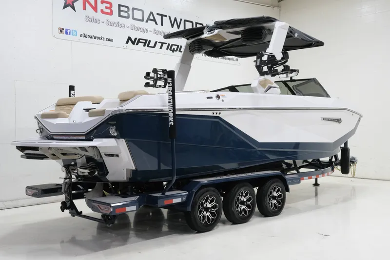 Slide: The Image of A modern 2027 Nautique G25 on a trailer in a showroom. - 3