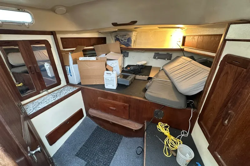 Slide: The Image of Interior of 1980 Morgan 415 Ketch sailboat with storage boxes and cushions. - 7