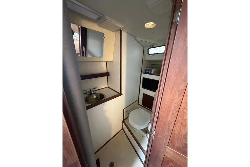 Slide: The Image of Interior of 1980 Morgan 415 Ketch bathroom with sink, toilet, and storage. - 8
