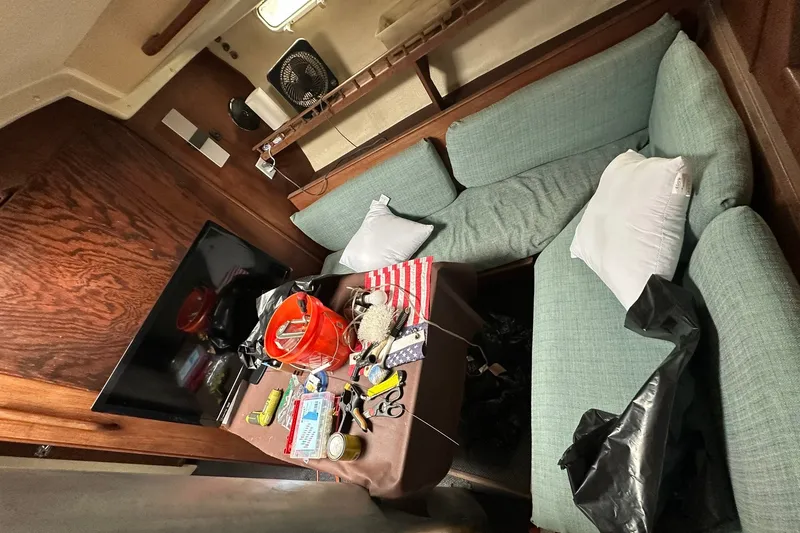 Slide: The Image of Interior of a 1980 Morgan 415 Ketch sailboat with cozy seating and nautical decor. - 16