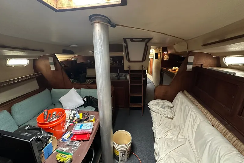 Slide: The Image of Interior of a 1980 Morgan 415 Ketch sailboat with cozy seating and nautical decor. - 20