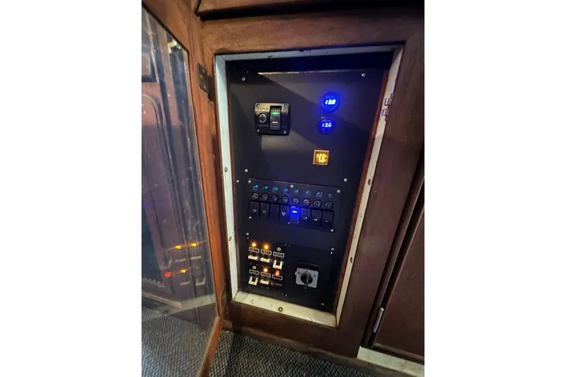 Slide: The Image of Electrical panel inside a 1980 Morgan 415 Ketch sailboat, featuring switches and voltage displays. - 12