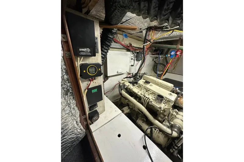 Slide: The Image of Engine room of a 1980 Morgan 415 Ketch sailboat with visible wiring and controls. - 11