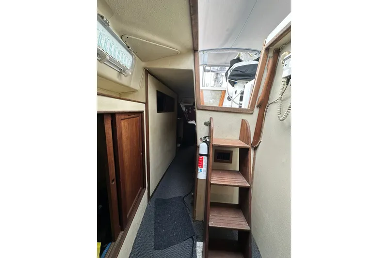 Slide: The Image of Interior of 1980 Morgan 415 Ketch sailboat with wooden stairs and storage. - 9