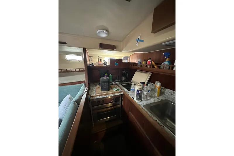 Slide: The Image of Interior of 1980 Morgan 415 Ketch sailboat kitchen with stove, sink, and storage. - 21