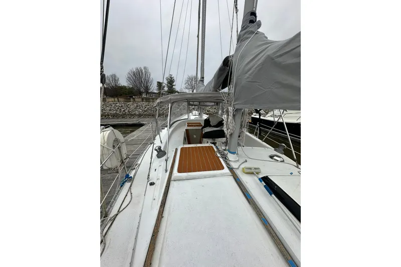 Slide: The Image of 1980 Morgan 415 Ketch sailboat docked, showcasing deck and rigging. - 3