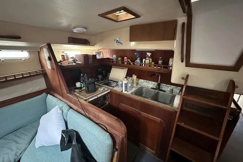 Slide: The Image of Interior of 1980 Morgan 415 Ketch sailboat with kitchen and seating area. - 15
