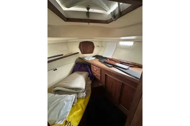 Slide: The Image of Interior cabin of a 1980 Morgan 415 Ketch sailboat with wooden furnishings and bedding. - 18