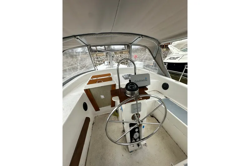 Slide: The Image of 1980 Morgan 415 Ketch cockpit with steering wheel and Garmin navigation system. - 6