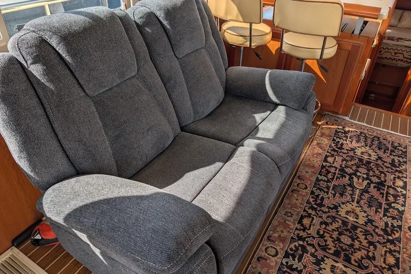 Slide: The Image of Interior of 2008 Mainship 34 Trawler with gray sofa and patterned rug. - 24