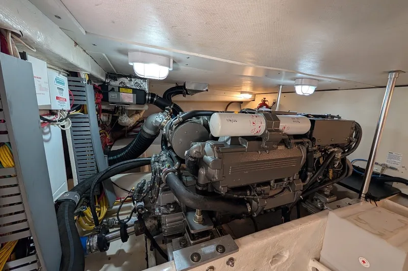 Slide: The Image of Engine room of a 2008 Mainship 34 Trawler, showcasing mechanical components and wiring. - 47