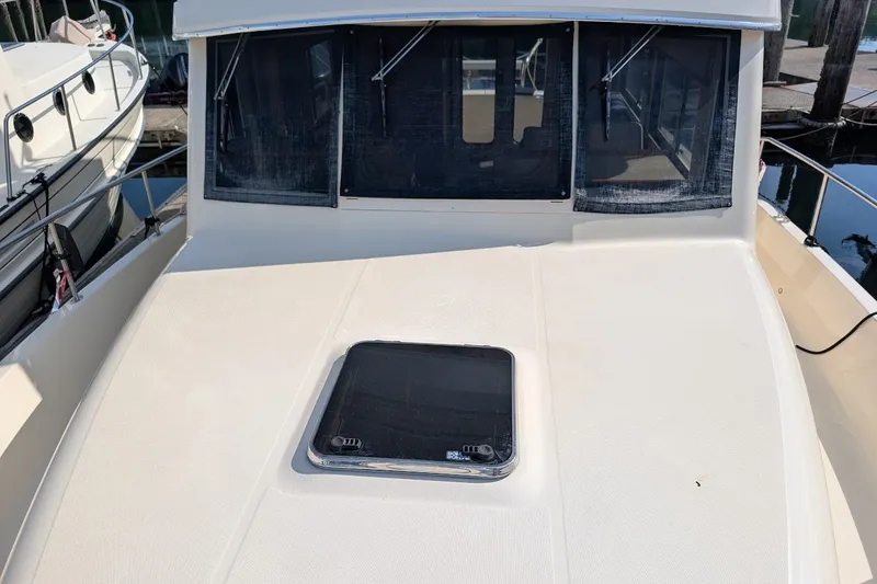 Slide: The Image of 2008 Mainship 34 Trawler boat deck with hatch, docked at marina. - 43