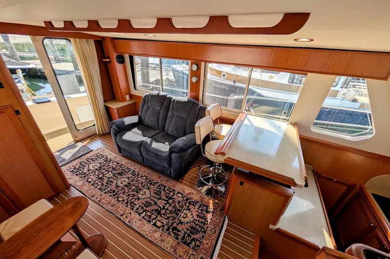 Slide: The Image of Interior of 2008 Mainship 34 Trawler with cozy seating and elegant wood finishes. - 17