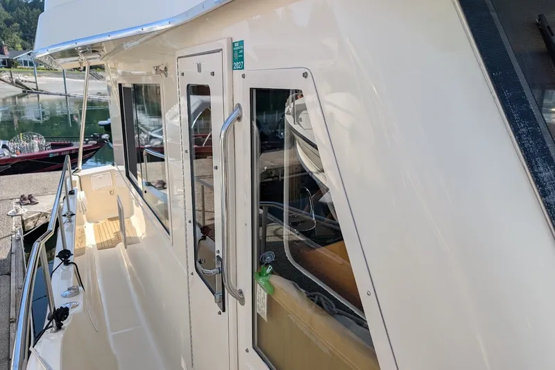 Slide: The Image of 2008 Mainship 34 Trawler docked, showcasing sleek exterior and modern design. - 42