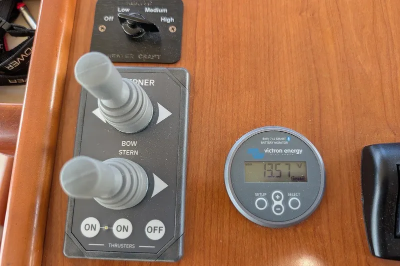 Slide: The Image of Control panel of 2008 Mainship 34 Trawler with thruster controls and battery monitor. - 34