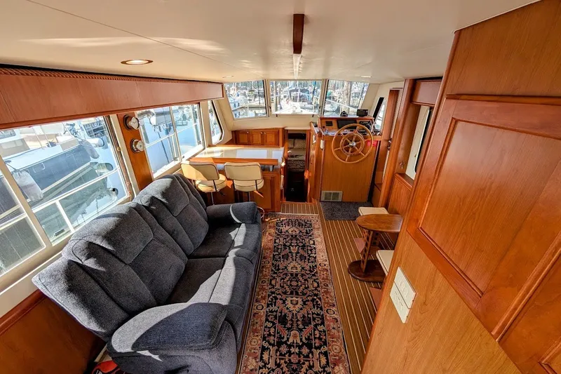 Slide: The Image of Interior of 2008 Mainship 34 Trawler with cozy seating and wooden accents. - 16