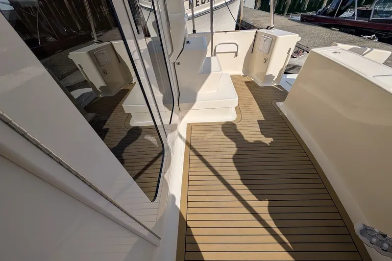 Slide: The Image of 2008 Mainship 34 Trawler deck with teak flooring and modern design elements. - 40