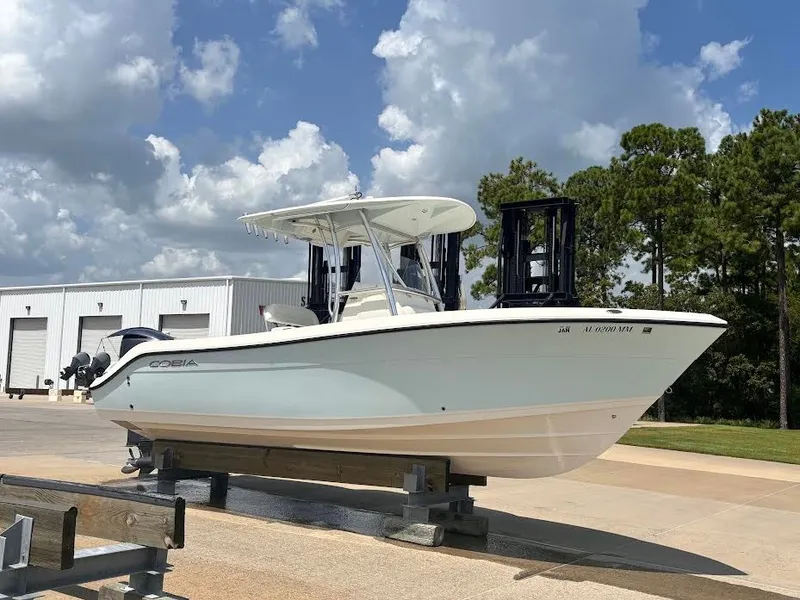 The Image of A 2014 Cobia 237 Center Console boat on a stand. It features a white hull design. - 0