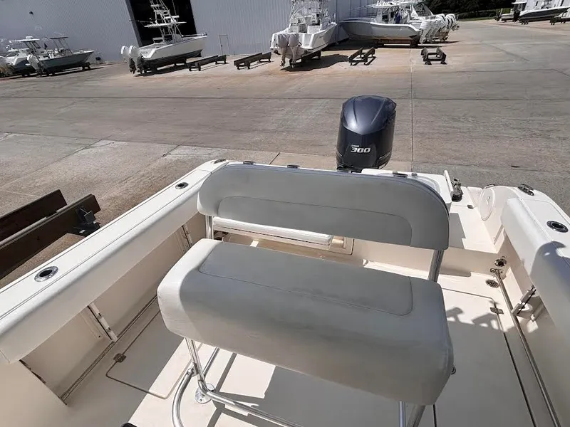Slide: The Image of The image shows the cockpit of a 2014 Cobia 237 Center Console boat with a 300 HP engine. - 13