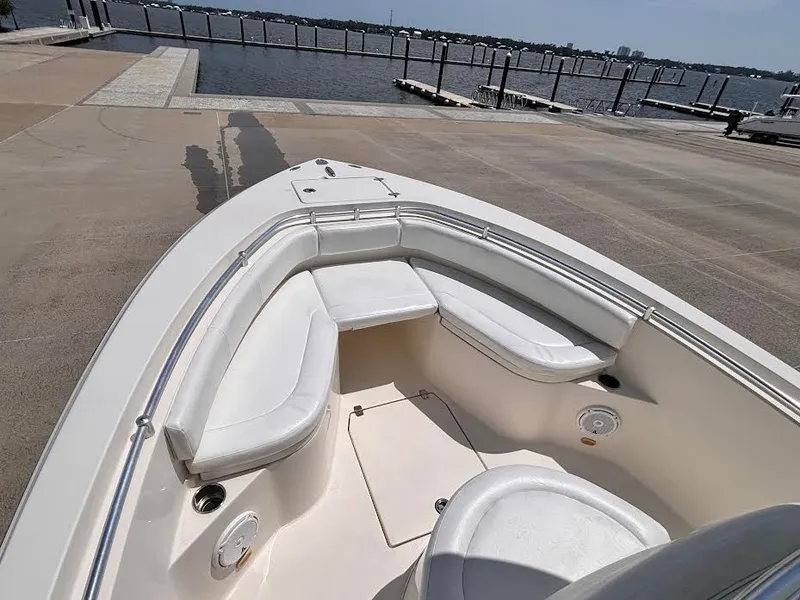 Slide: The Image of The image shows the bow of a Cobia 237 Center Console boat with white cushions. - 17