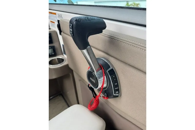 Slide: The Image of Throttle control of a 2018 Regal 28 Express boat with red safety lanyard. - 8
