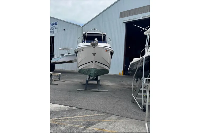 Slide: The Image of 2018 Regal 28 Express boat on stand outside storage facility. - 1